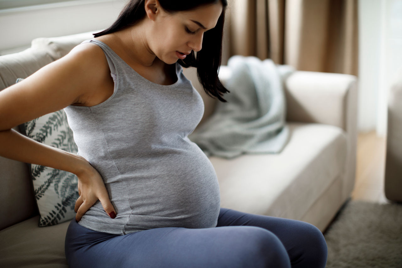Young pregnant woman suffering from backache